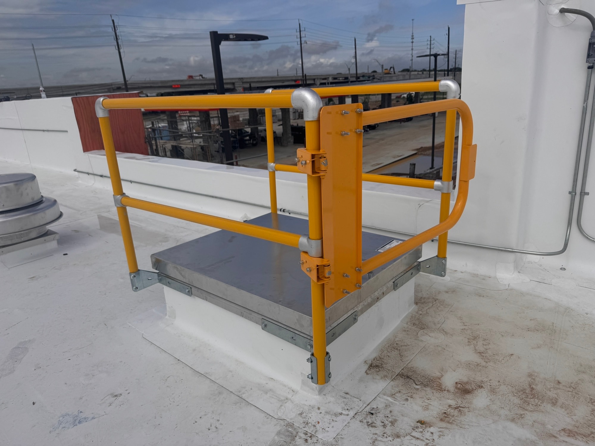 Yellow safety cage platform on commercial rooftop