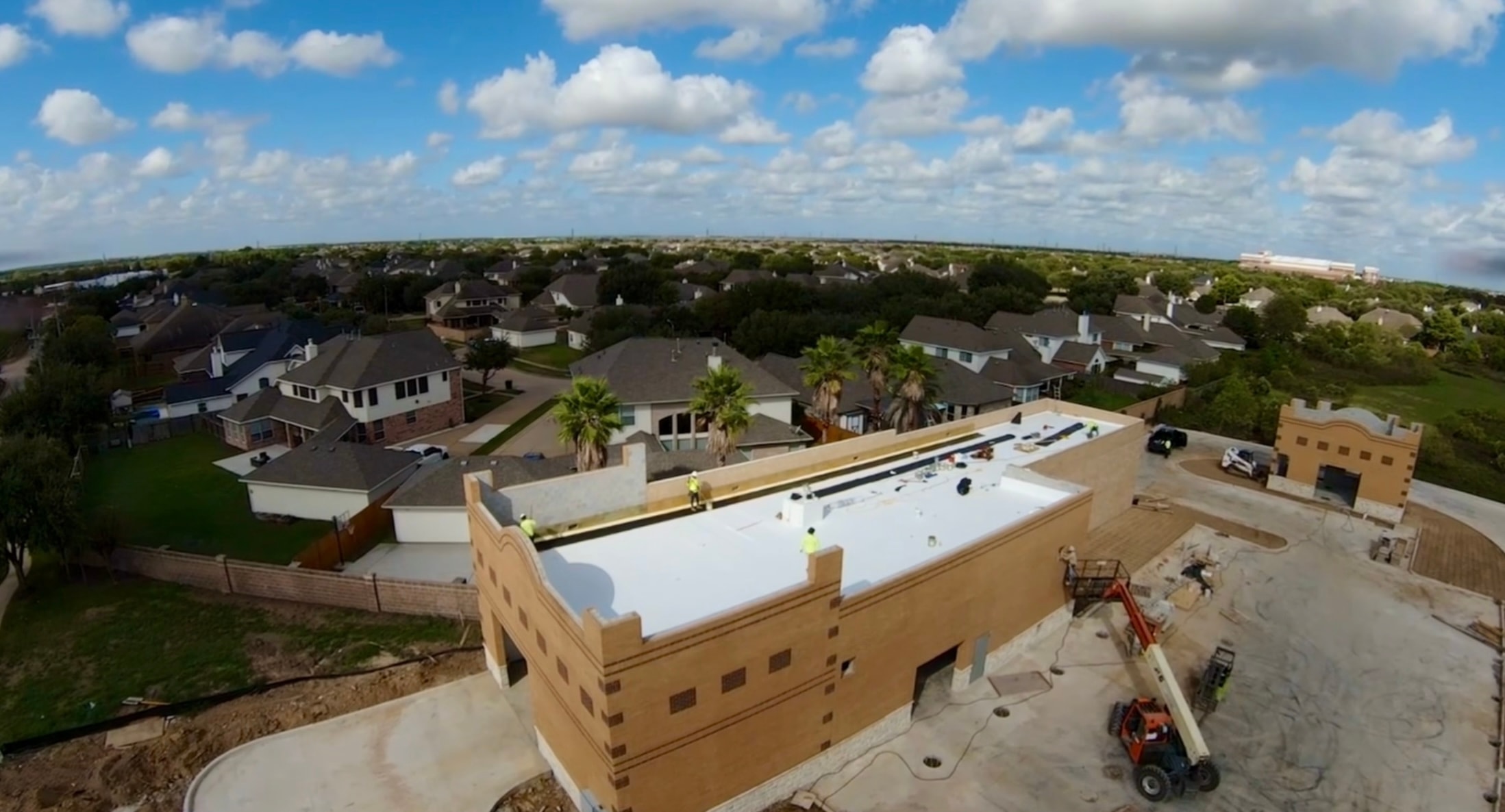 Aerial drone shot of new construction flat roof installation